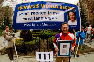 Ashrita posing with his Guinness World Record Certificate for 100 GWRs