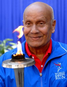 Sri Chinmoy holding the World Harmony Run Torch