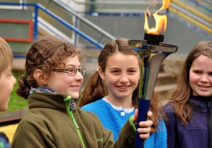 school children holding the World Harmony Run torch in Trier Quint primary school