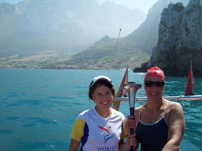 Gibraltar Straits Swim 2012 - Vasanti`s Swim to Africa, holding the World Harmony Run torch at the finish Gibraltar Straits Swim 2012 - Vasanti`s Swim to Africa, holding the World Harmony Run torch at the finish