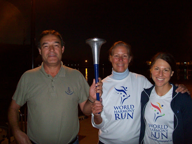 Holding the World Harmony Run torch with Rafael, head of ACNEG, the organisation for Gibraltar Strait swims - Vasanti`s Gibraltar Straits swim 2012 Holding the World Harmony Run torch with Rafael, head of ACNEG, the organisation for Gibraltar Strait swims - Vasanti`s Gibraltar Straits swim 2012